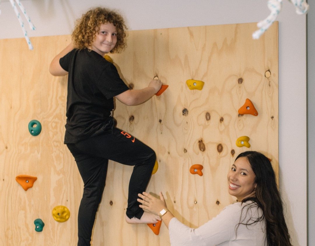 Boy climbing indoor rock wall