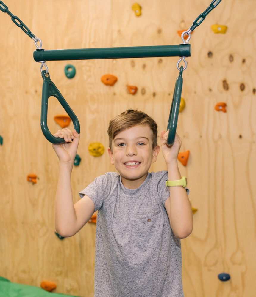 Boy playing on an acrobat swing