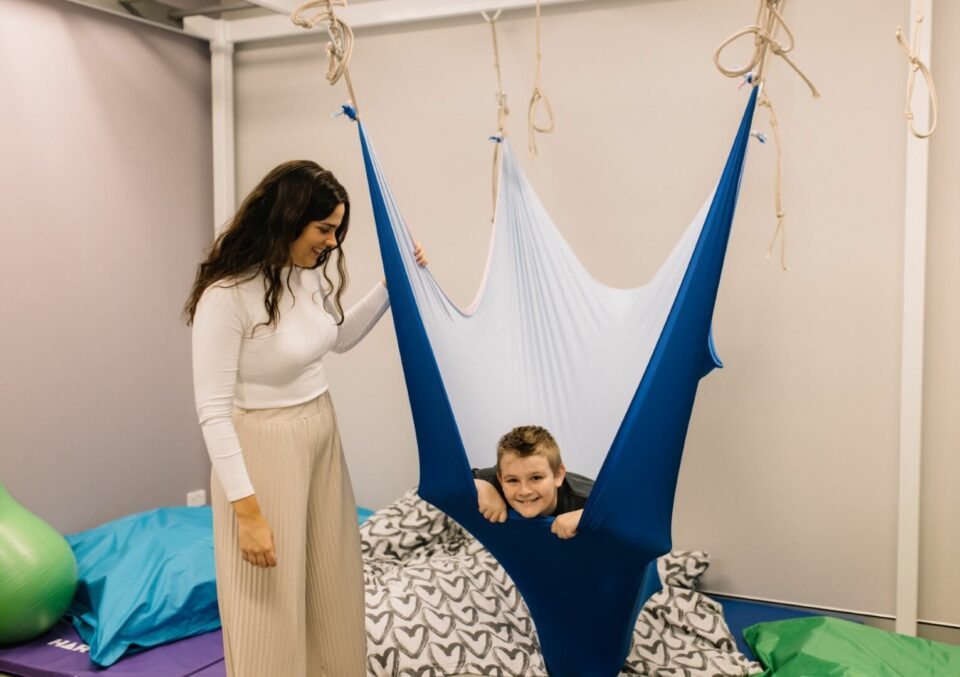 Belinda with boy in stretchy swing