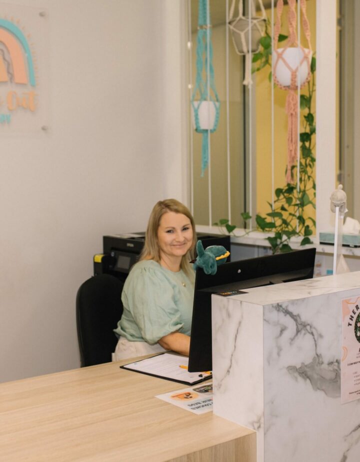 Brooke sitting at reception desk