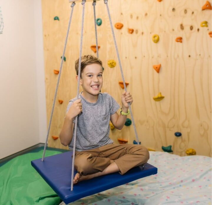 Boy on indoor swing
