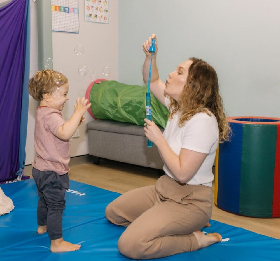 Marissa blowing bubbles with boy