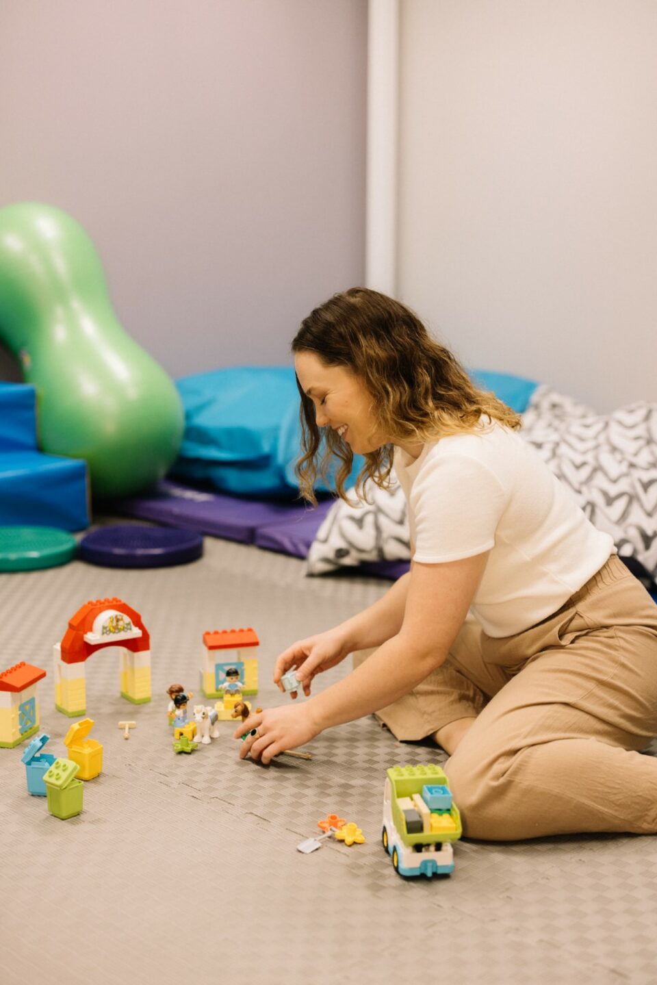 Marissa playing with toys on play mat