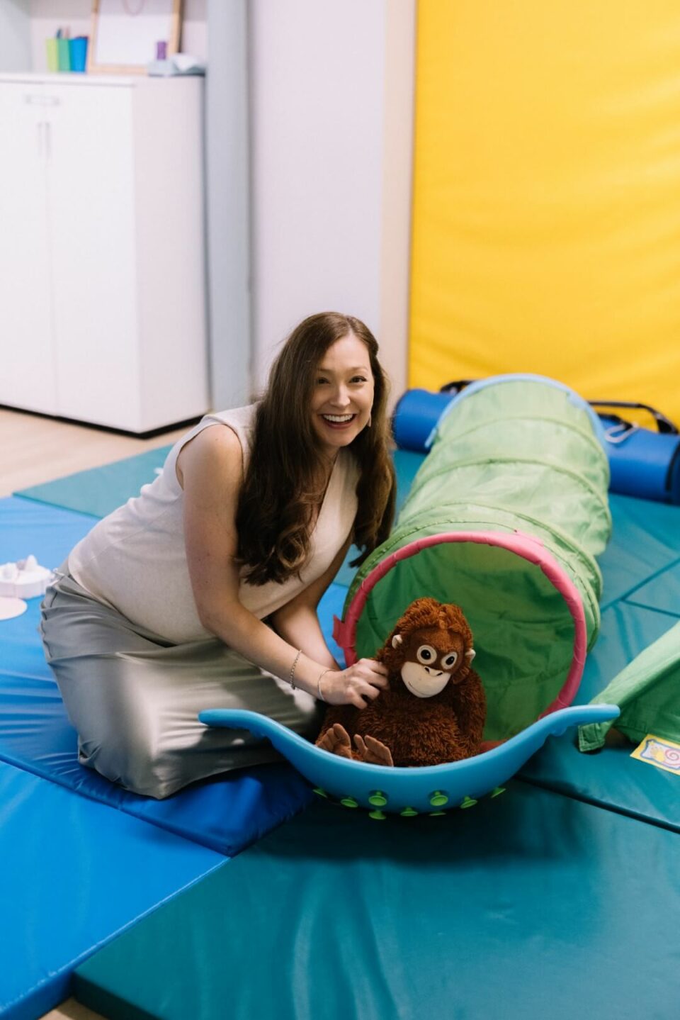 Melissa playing with monkey in tunnel
